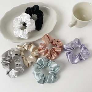 Set of seven colorful satin scrunchies in silk-like fabric for ponytail styling