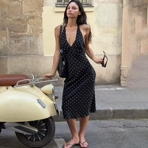 Robe à pois dos nu avec décolleté en V profond et dos ouvert sur un fond vintage chic