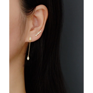 Close-up of S925 sterling silver gold fringe earrings with rectangular zircon on model