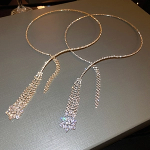 Detail of silver choker necklaces with sparkling zircon tassels and elegant fringed layers