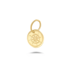 Detailed macro view of a round gold compass pendant with intricate star engraving
