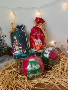 Christmas gift set with festive coral fleece socks in decorative balls and velvet bags