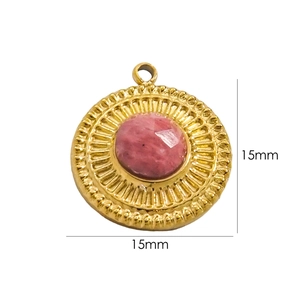 Detail of a 15mm sunburst gold pendant with a central pink stone inlay