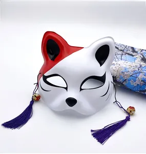 Close-up of Japanese Kitsune mask with purple tassels and golden bells for cosplay