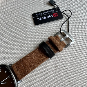 Detail of brown suede leather watch strap with silver buckle and VIKEC waterproof tag