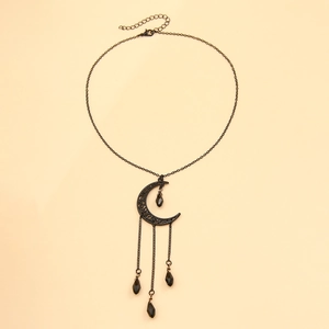 Macro detail of gothic choker with black crescent moon and dangling resin water drops