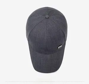 Detail view of dark grey baseball cap with heather texture and metal side ornament