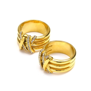 Cross layered 18k gold rings with inset diamonds shown on a clean white background