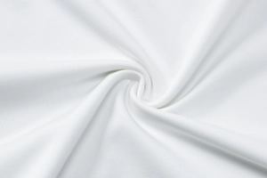 Close-up of white knit fabric texture showing spiral weave and soft premium material
