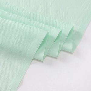 Close-up of light green imitation cashmere scarf showing soft texture and weave detail