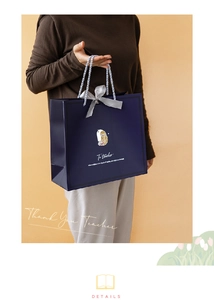 Detail of dark blue gift bag with silk bow and inspirational quote for teachers