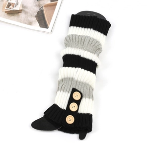 Close-up of knit leg warmers with black grey white stripes and vintage wooden buttons