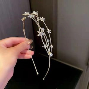Close-up of gold star headband with sparkling rhinestones and elegant pearls
