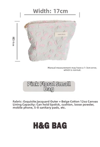 Detail view of pink floral jacquard makeup bag showing dimensions of 17cm by 14cm