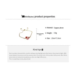Detailed view of 18k gold plated copper bracelet with red zircon heart and white stones