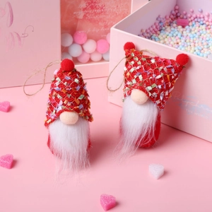 Detail of red festive gnomes with knitted hats and plush beards on a pink gift background