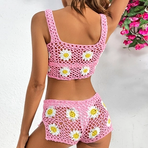 Detailed back view of pink crochet bikini set with white daisy floral knit patterns