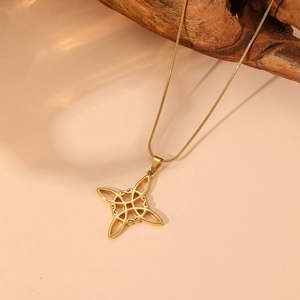 Close-up of golden Celtic knot pendant with opal and crystals on snake chain