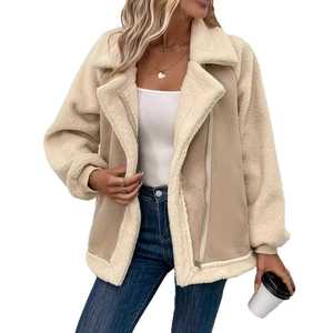 Detailed view of women's warm faux shearling lapel jacket with beige suede and white lining