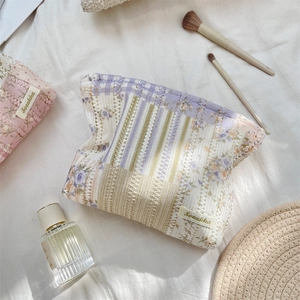 Detail of floral quilted makeup bags with lace trim and soft cotton fabric texture