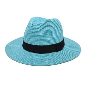 Detail of sky blue straw Panama hat with wide black grosgrain ribbon weave texture