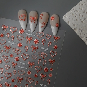 Detail of 3D embossed Christmas nail art stickers with red white candy cane heart patterns