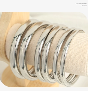 Macro shot of 18K gold plated minimalist bangles displayed on a premium jewelry stand