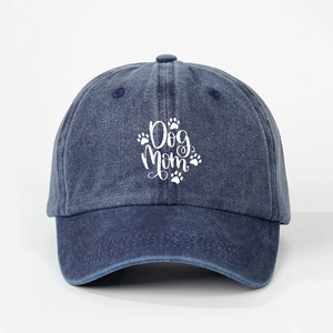 Close-up of vintage washed navy cotton baseball cap with white Dog Mom text and paw prints