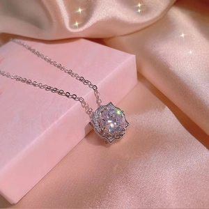 Elegant silver starburst zircon necklace displayed on premium pink silk gift box