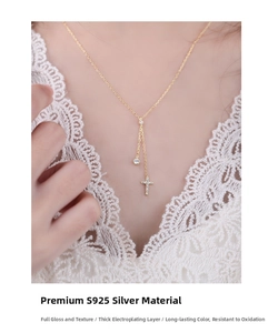 Close-up of S925 silver cross necklace with pavé zircon and elegant tassel pendant on model