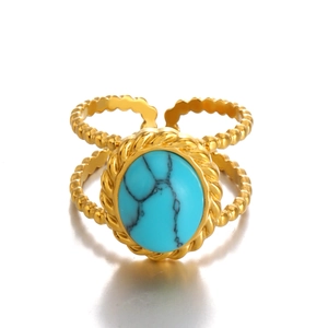 Gold adjustable ring with oval turquoise and beaded double-row bezel on white background