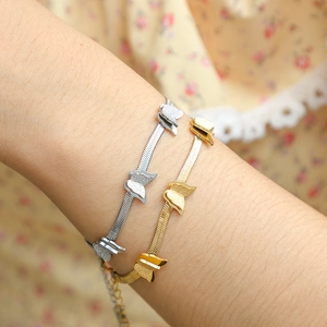 Close-up of gold and silver titanium steel butterfly bracelets on a model wrist
