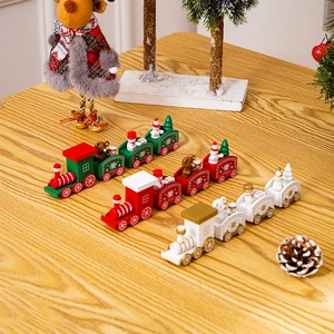 Three festive wooden Christmas trains with snowmen and bears on a light wood background
