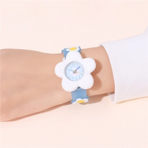 Close-up of a child wearing a blue silicone watch with a white flower-shaped case