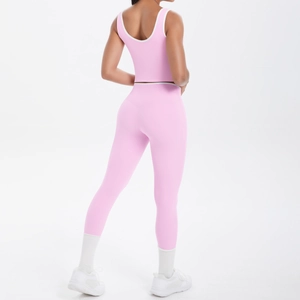 Rear view of pink yoga set with racerback top and high-waisted leggings featuring white trim