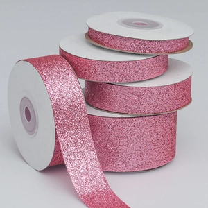 Close-up of pink glitter polyester ribbons in various widths for gift wrapping