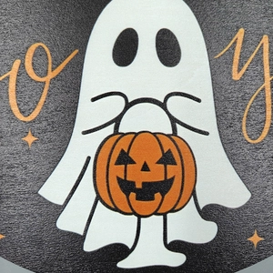 Close-up of Halloween wooden hanging sign featuring a white ghost holding a pumpkin