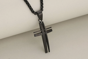 Detail view of the black stainless steel hollow cross pendant with sleek box chain links