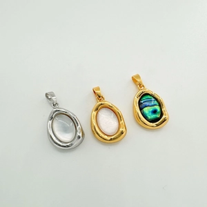 Detailed macro view of 18K plated oval shell pendants in gold and silver finishes