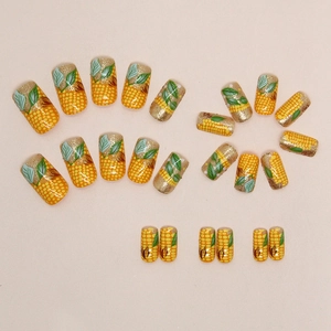Medium long harvest yellow corn nails with gold glitter gradient and leaf pattern art