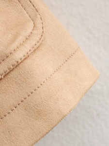 Detail of khaki faux suede fabric featuring high-density double stitching and soft texture
