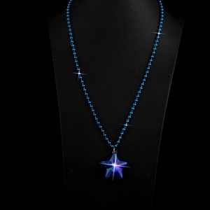 Handmade blue beaded necklace with a sparkling star-shaped resin pendant on black display