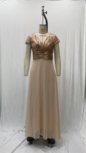 Detail of rose gold sequins V-neck bodice and pleated waist on champagne evening gown