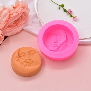 Pink silicone moon face mold with detailed relief carving for handmade soap and baking