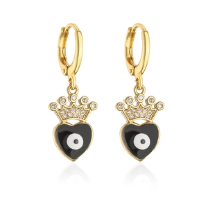 Detail of gold-plated hoop earrings featuring black heart charms and evil eye crowns