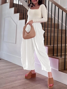 Detail of white high waist wide leg pants with elastic drawstring and side pockets
