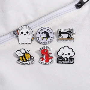 Set of 6 cartoon enamel pins featuring bee, dinosaur and sewing machine on white canvas