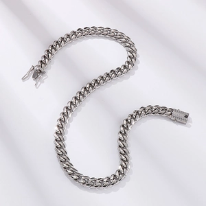 Macro detail of silver CNC Cuban chain link featuring iced-out pavé set rhinestones
