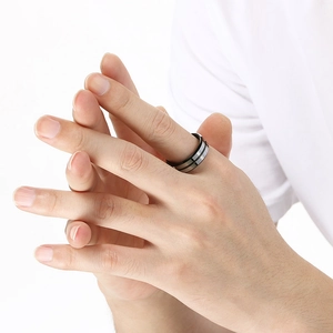 Macro detail of men's tungsten ring with black brushed finish and silver polished edges