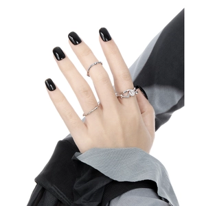 Three minimalist silver S925 rings with hollow diamond design on female hand